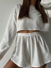 White perforated crop top and shorts set with elastic waistband and crew neck.