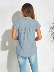 Light blue textured dot poplin shirt with short sleeves and a collared neckline.