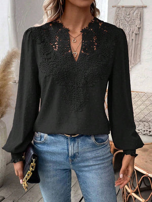 Black embroidered yoke blouse with puff sleeves and textured fabric.
