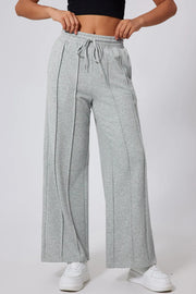 Gray seamed wide leg lounge trousers with drawstring waist and relaxed fit.