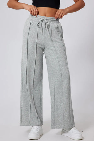 Gray seamed wide leg lounge trousers with drawstring waist and relaxed fit.