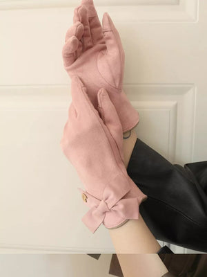Pink suede gloves with bow detail and button accent