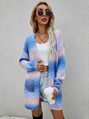 Rainbow gradient knit cardigan with pockets, open front, long sleeves, and a relaxed fit.