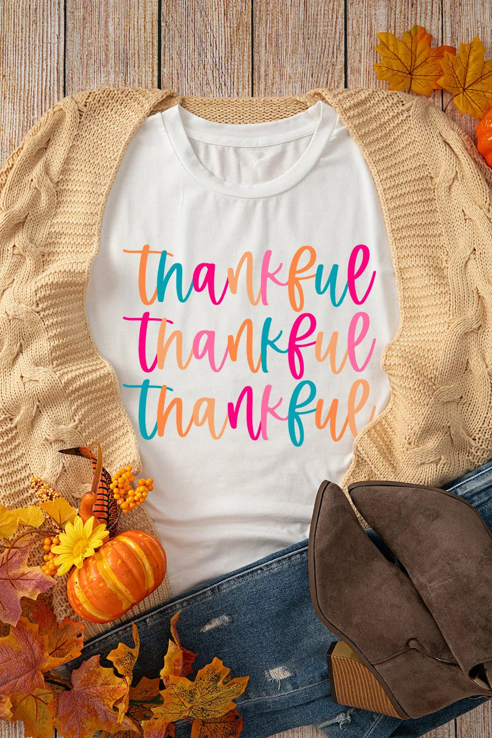 White graphic tee with stacked "thankful" text in colorful script, casual fall styling