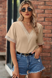 Cream v-neck blouse with lace trim on neckline and short sleeves