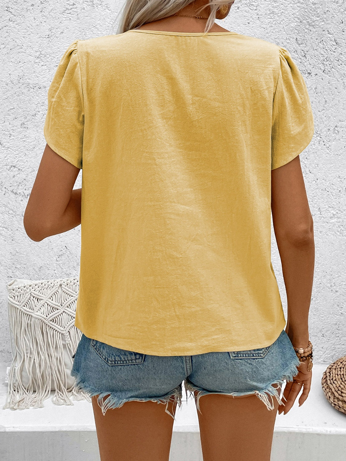 Yellow linen blouse with puff sleeves and a mandarin collar, styled with denim shorts.