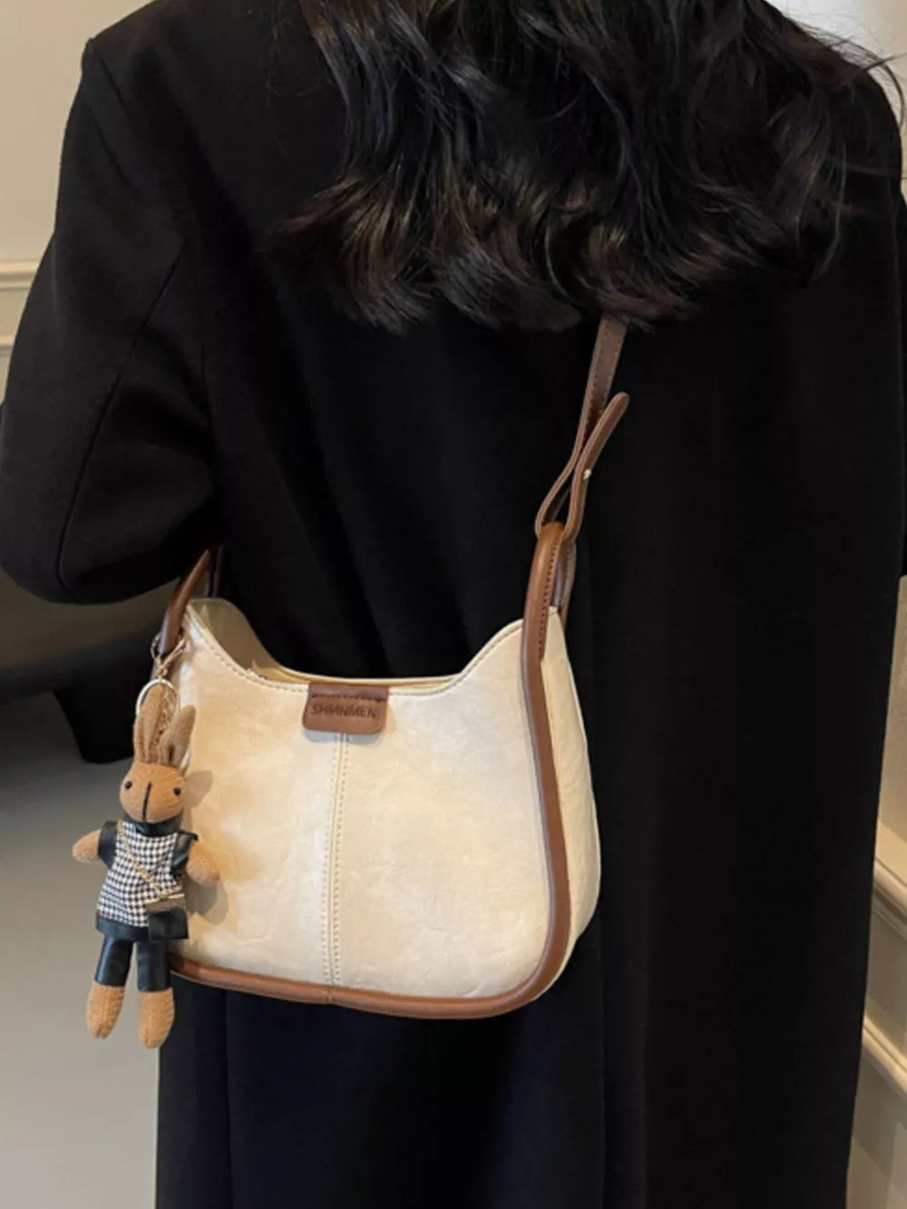 Off-white pu leather shoulder bag with brown piping and bunny charm
