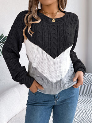 Black chevron cable knit sweater with white and grey colorblock detail.