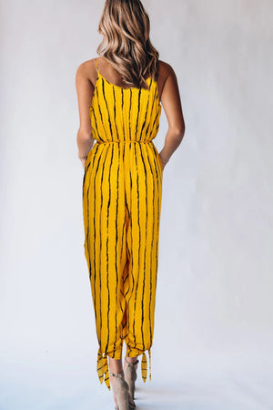 Gold striped wrap jumpsuit with spaghetti straps and ankle ties.