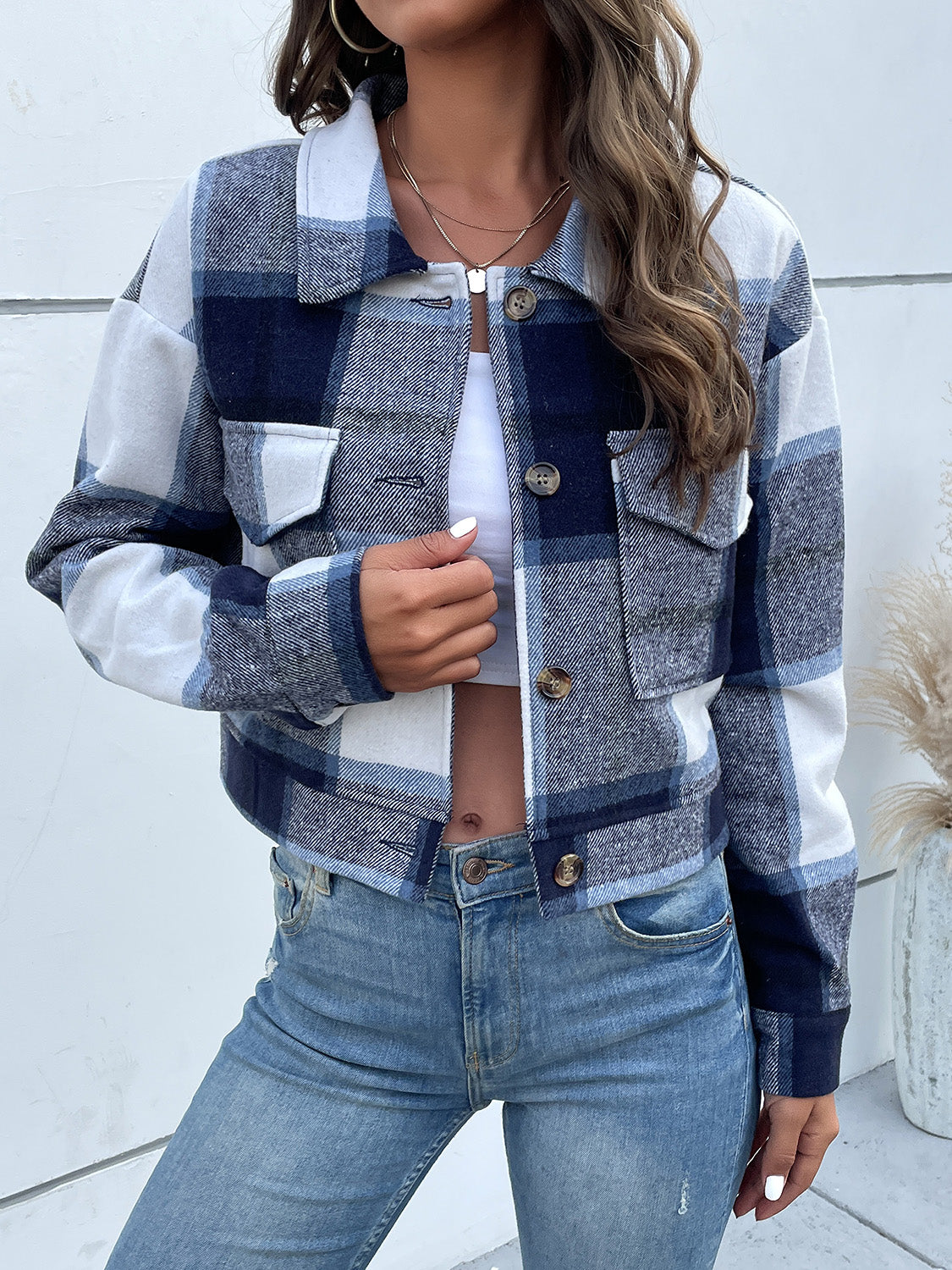 Checked plaid shacket in blue and white with patch pockets and button closure.