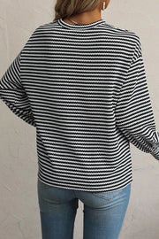 Black and white striped long sleeve tee with a crew neck, casual fit.