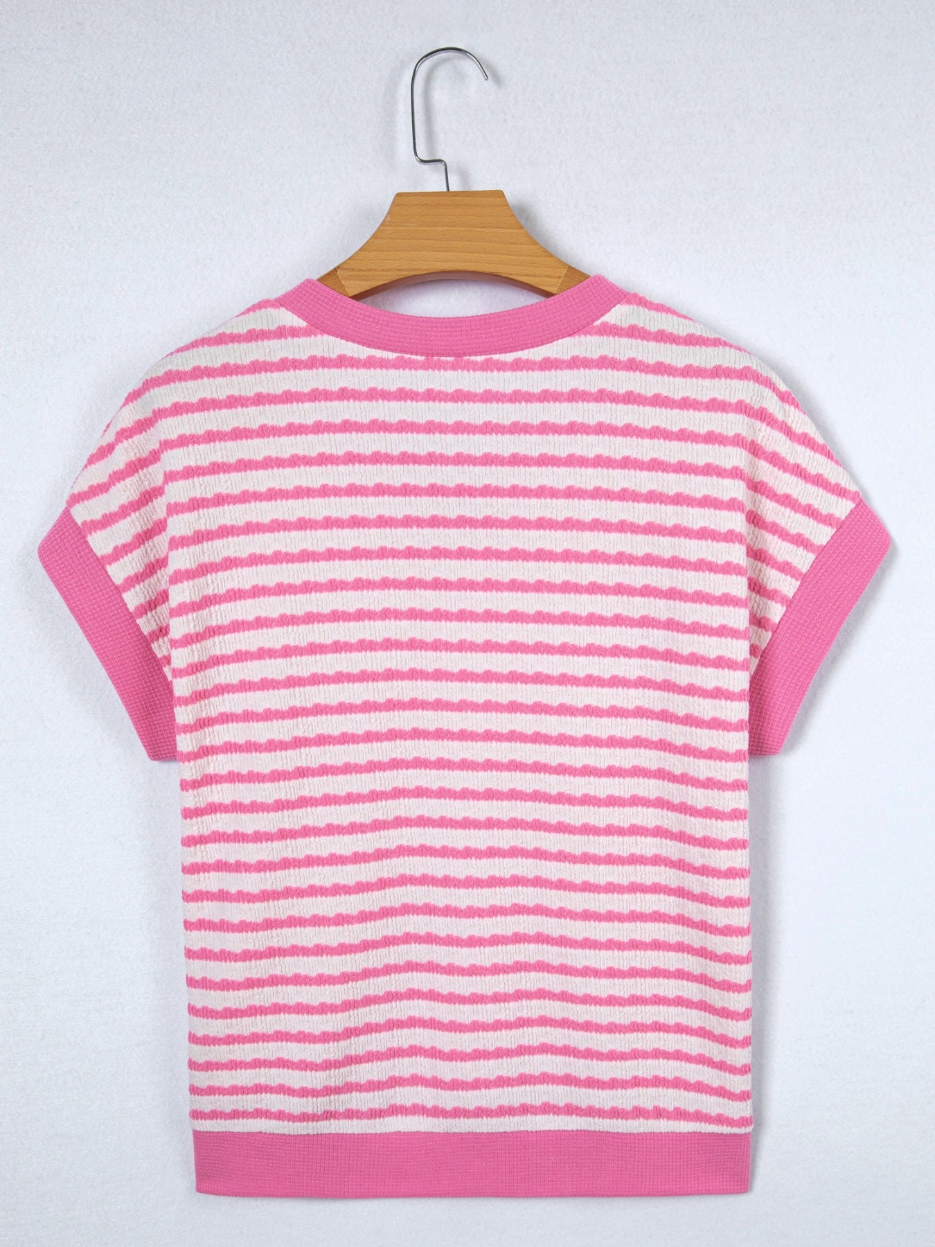 Textured pink and white striped V-neck t-shirt with short sleeves.