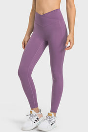 Purple performance leggings with sculpted waistband and side pockets.