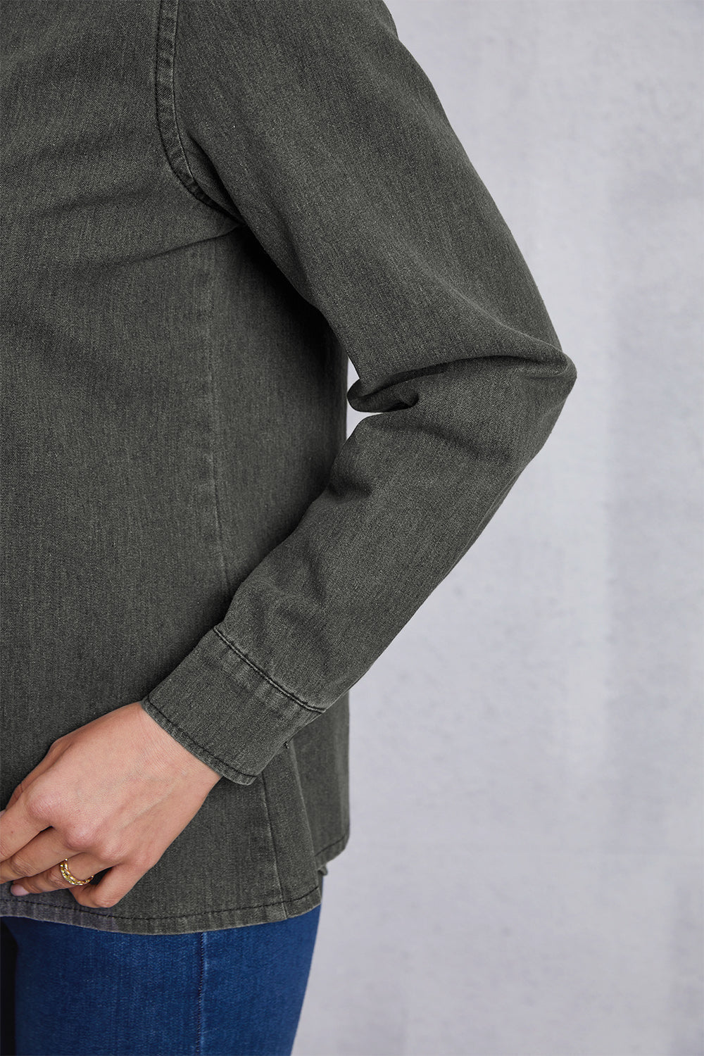 Washed dark gray denim shirt with pointed collar and button cuffs.