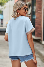 Light blue short sleeve blouse with lace trim on sleeves