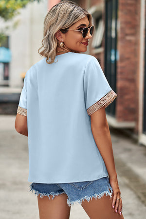 Light blue short sleeve blouse with lace trim on sleeves