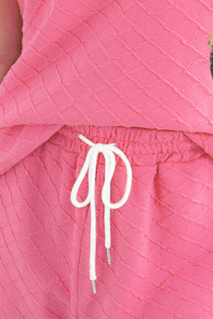 Textured knit loungewear set in fuchsia pink with drawstring waist and relaxed fit.