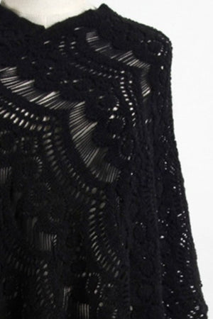 Black crochet poncho with open knit pattern and fringe detail