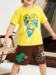 Yellow cotton t-shirt with sports ball graphics and brown shorts with dinosaur and soccer net prints.