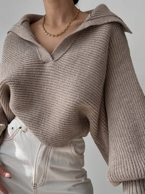 Tan knit sweater with wide collar and balloon sleeves, V-neckline.