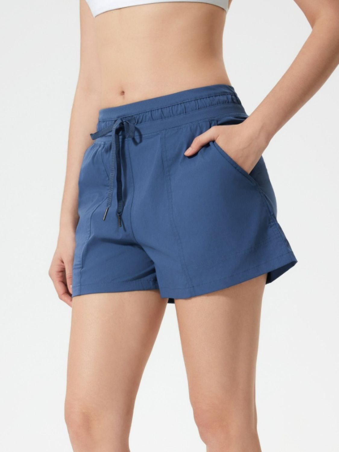 Dusty Blue utility shorts with drawstring waist and pockets.