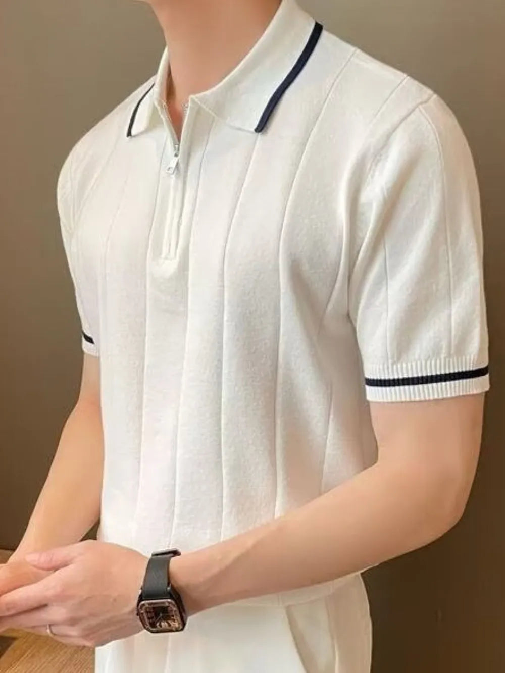 Ivory ribbed polo shirt with zip neck and contrast trim on collar and sleeves.