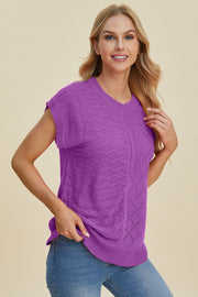 Purple knit patchwork top with cable and openwork details, short sleeves, and crew neck.