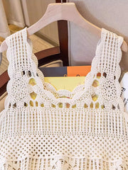 Cream crochet tank top with floral overlay detail and scalloped neckline.