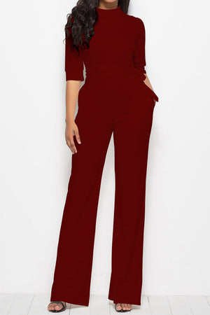 Burgundy high-neck belted palazzo jumpsuit with 3/4 sleeves and pockets.