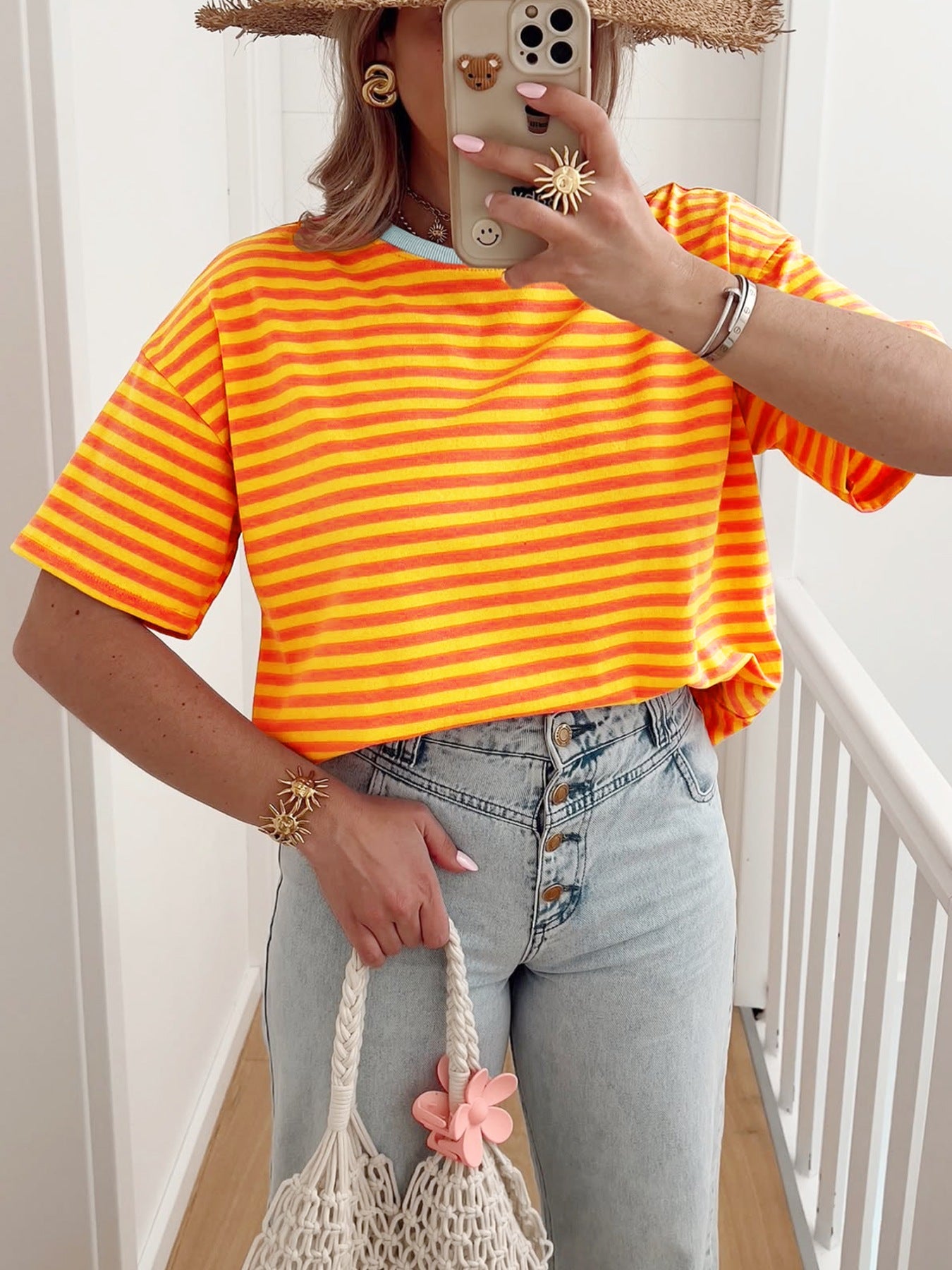 Tangerine and yellow striped cotton t-shirt with round neck and short sleeves.