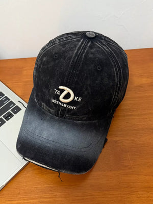 Embroidered vintage denim baseball cap in dark gray with distressed brim and white lettering.