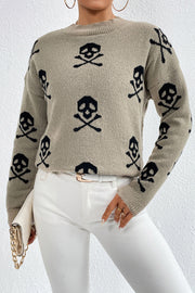 Cosmic motif mock neck knit sweater in khaki with black skull and crossbones pattern.