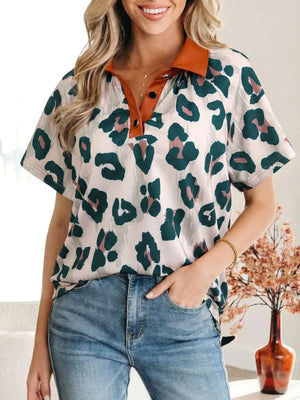 Print short sleeve blouse with animal print, brown collar, and button detail.