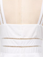 White midi dress with eyelet embroidery detail on straps and horizontal cutouts.