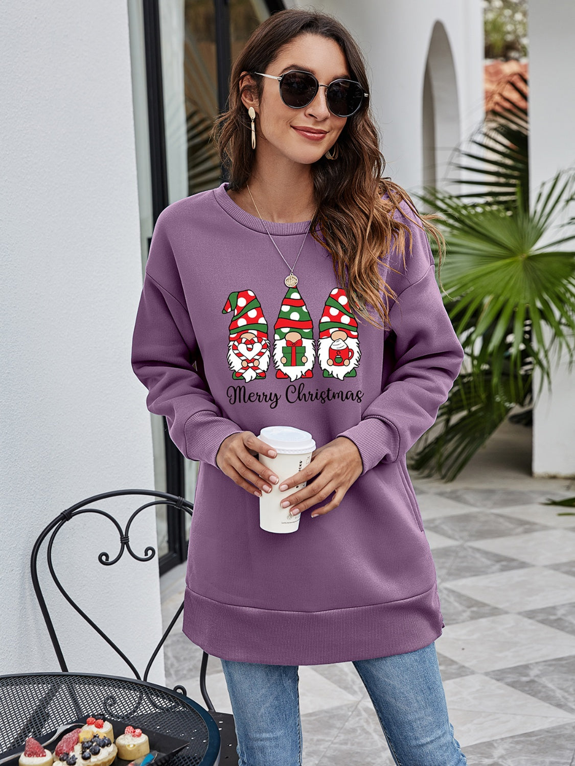 Purple tunic sweatshirt with Christmas gnomes and Merry Christmas graphic.