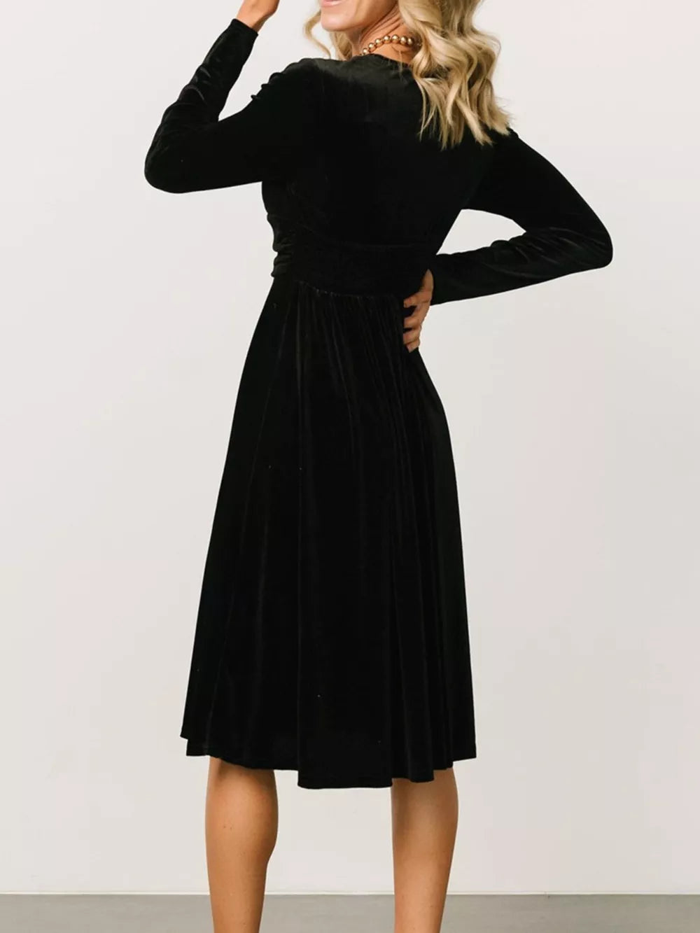 Black velvet midi dress with long sleeves and a-line skirt.