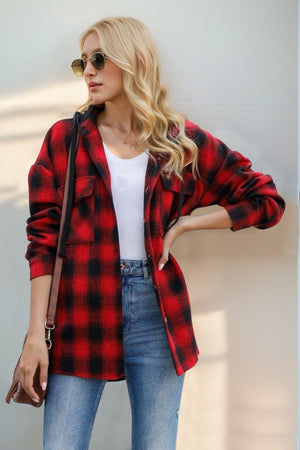 Oversized red and black plaid hooded shirt jacket with button front and chest pockets.