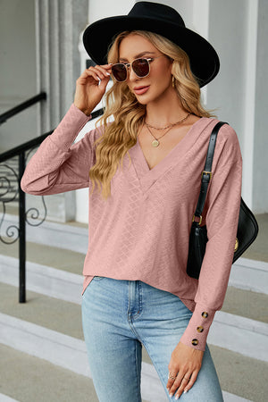 Blush pink diamond-textured v-neck blouse with button cuffs