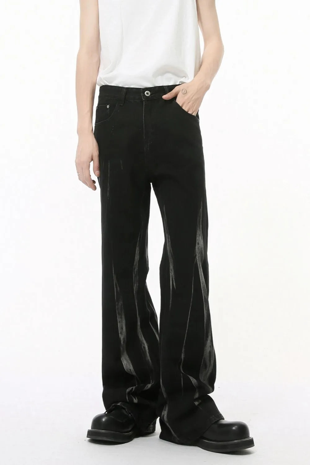 Faded flare denim jeans in dark wash with distressed detailing and a relaxed fit.