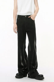 Faded flare denim jeans in dark wash with distressed detailing and a relaxed fit.