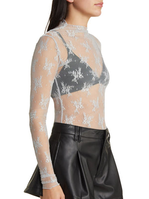 Floral lace mock neck top in light blue with long sleeves, sheer fabric, and snowflake pattern.
