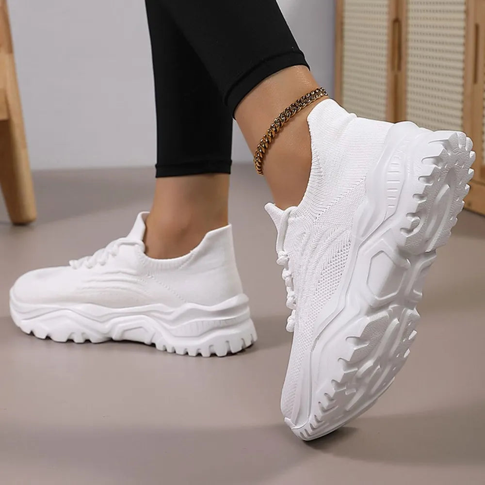White textured knit sneakers with a chunky sole and laces.