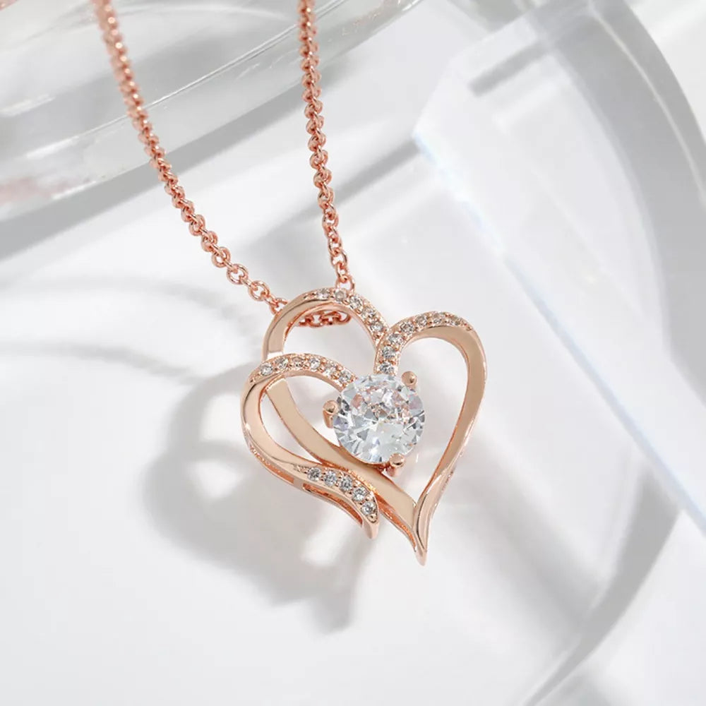 Rose gold heart pendant necklace with cubic zirconia and delicate chain.