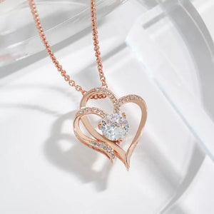 Rose gold heart pendant necklace with cubic zirconia and delicate chain.
