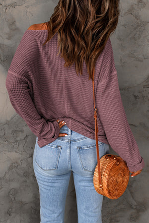 Dusty purple waffle knit v-neck pullover sweater with long sleeves.