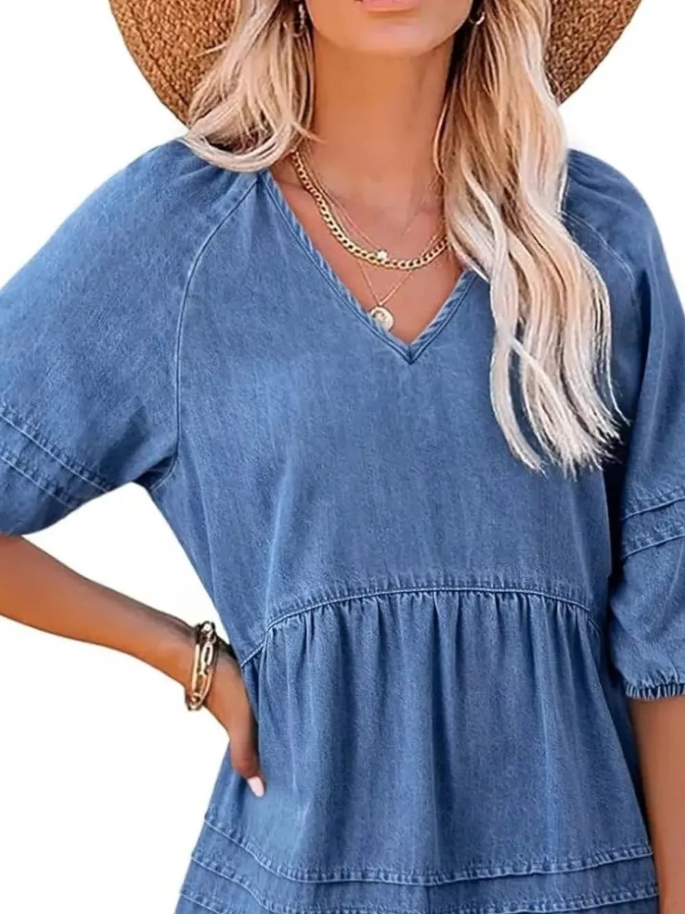 Denim mini dress with V-neck, puff sleeves, and tiered skirt in blue.