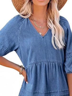 Denim mini dress with V-neck, puff sleeves, and tiered skirt in blue.