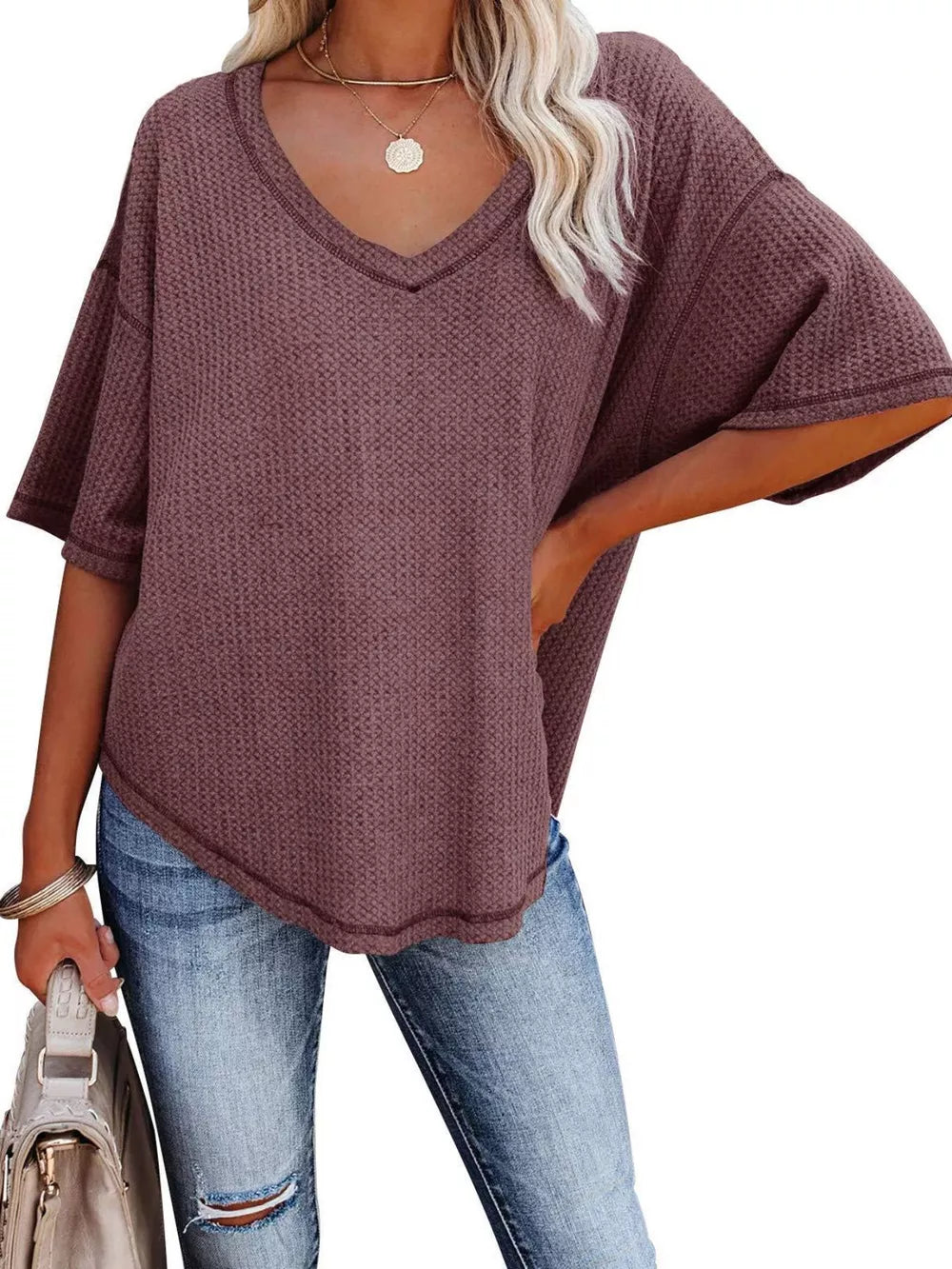 Maroon waffle knit relaxed v-neck t-shirt with short sleeves and a curved hem.