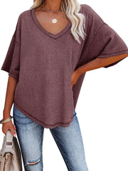 Maroon waffle knit relaxed v-neck t-shirt with short sleeves and a curved hem.
