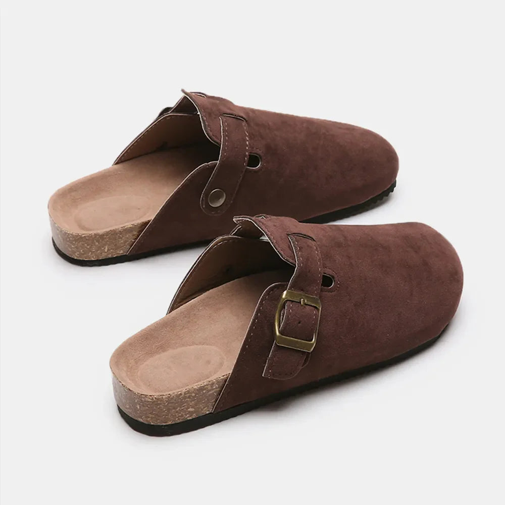 Chocolate suede clog slides with cork sole and adjustable buckle strap.